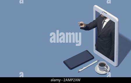 Businessman in a smartphone pointing at blank copy space, he is interacting with an user interface or showing a message Stock Photo