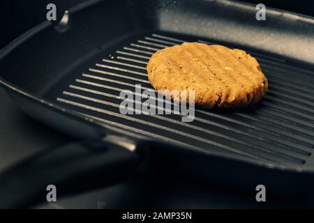 vegan burger cooking on the iron, vegetarian food and healthy lifestyle concept Stock Photo