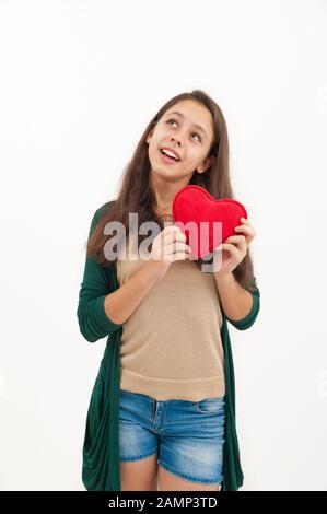 Teen girl with a plush toy heart on a white background Stock Photo