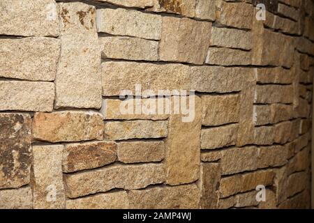 Close-up shot of a stone wall made of cut sandstone blocks. Stock Photo