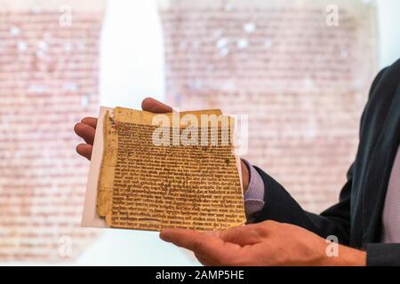 14 January 2020, Saxony-Anhalt, Lutherstadt Wittenberg: Matthias Piontek, deputy director of the 'Wittenberg Research Library for the History of the Reformation', presents a fragment of parchment in German from the Gospel of Nicodemus. The gospel of Nicodemus is an apocryphal gospel, so it does not belong to the text of the Bible. The author was Heinrich von Hesler. The researcher had found the fragment in the old inventory of his institution. The text is dated 1220 and was discovered as a book cover during inventory inspections. The parchment can be seen from 21 February to 20 May in Wittenbe Stock Photo