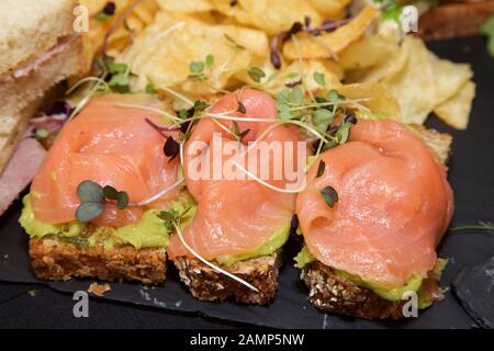 Close-up shot of a smoked Salmon with Guacamole on Brown Bread appetizer. Stock Photo