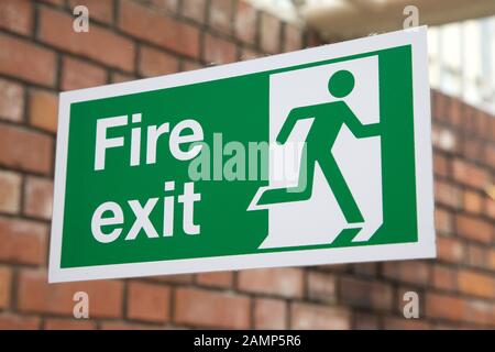 Fire exit sign in a public building. Stock Photo