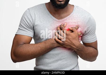 Cropped of young black man having heart attack Stock Photo