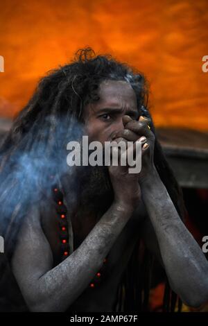 Allahabad, India. 14th Jan, 2020. Allahabad: A sadhu smoke chillum at Sangam on the eve of Makar Sankranti Festival during ongoing Magh Mela 2020 in Allahabad on Tuesday, January 14, 2020. (Photo by Prabhat Kumar Verma/Pacific Press) Credit: Pacific Press Agency/Alamy Live News Stock Photo