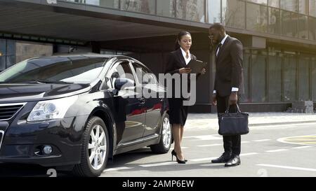 Showroom manager discussing car leasing contract with business client, services Stock Photo