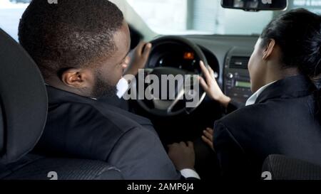 Female assistant flirting with boss in his car to move up career ladder, affair Stock Photo