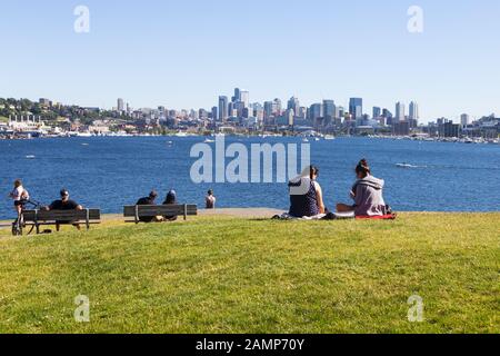 Seattle, USA - June 02 2018: People enjoy a sunny spring day in the Gas Works Park with the Seattle city skyline in the background in Washington state Stock Photo