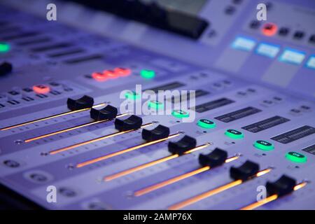 Fader switches on an audio mixing desk console. Stock Photo