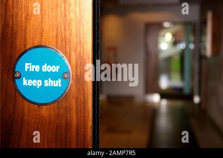 Fire door sign on a wooden door in a public building. Stock Photo