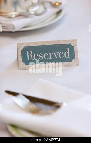 Reserved sign on a hotel breakfast table. Stock Photo