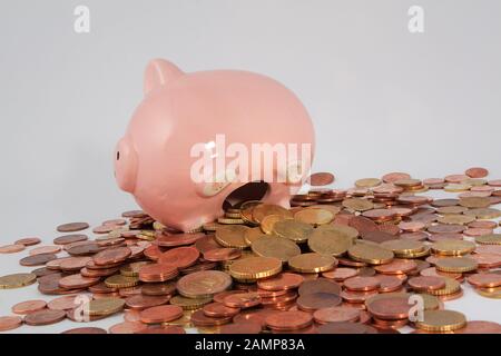 Piggy bank surrounded by an assortment of Euro coins. Stock Photo