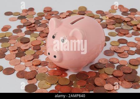 Piggy bank surrounded by an assortment of Euro coins. Stock Photo