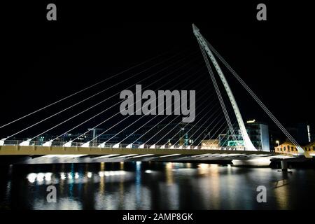 Dublin, Ireland - August 18, 2012: night time slow exposure shot of the Samuel Beckett Bridge on the river Liffey.