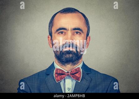 portrait of handsome hipster mature businessman with beard looking at you with serious and confident face expression. Mixed race bearded model isolate Stock Photo