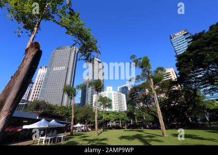 MANILA, PHILIPPINES - NOVEMBER 28, 2017: Skyline view from Ayala Triangle in Makati City, Metro Manila, Philippines. Metro Manila is one of the bigges