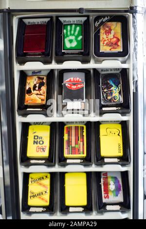 Zaporozhye, Ukraine. October 2019. A variety of lighters, zippo, piezo lighters, on the counter in the store. The general plan lighters with prints, g Stock Photo