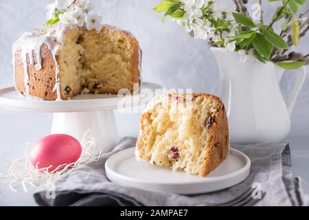 Easter orthodox cake and colorful red egg, spring flowers. Close up. Holidays traditional breakfast. Stock Photo