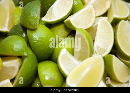 Food background - collection of vibrantly coloured lime wedges. Stock Photo