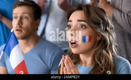 French football supporters watching final game together in pub, hope of victory Stock Photo