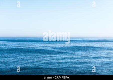 Ocean water and blue sky abstract background. Sea water texture closeup Stock Photo