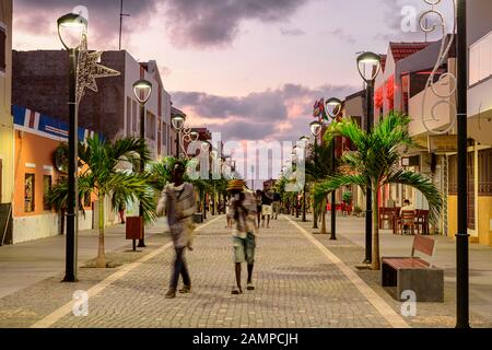 Pedestrian zone with poinsettia in the evening, Santa Maria, Sal Island, Cape Verde Stock Photo