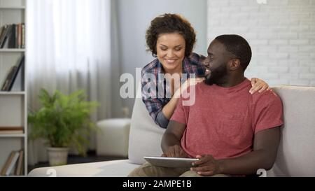 Happy married couple planning trip abroad, choosing hotels and airlines online Stock Photo