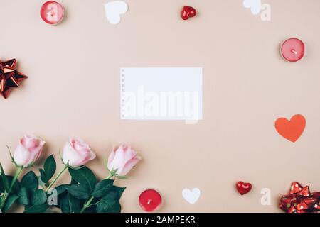 Heart of red ribbon and a border of red roses on a dark rustic ...