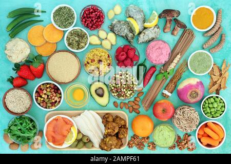 Super food for a healthy life concept with health foods high in antioxidants, anthocyanins, vitamins, minerals, protein, smart carbs, omega 3 & fibre. Stock Photo