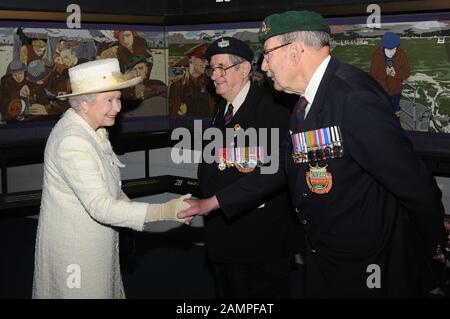 HM The Queen and Duke of Edinburgh visit the D-Day Museum in Portsmouth in 2009, dedicated to the decisive World War II victory 65 years after the Normandy invasion in June 1944. The Queen, wearing a cream coat and hat met D Day veterans Frank Rosier and Eddie Wallace  and viewed the Overlord Embroidery which charts the events of D-Day and features her father King George VI alongside Winston Churchill, Field Marshal Brooke and Generals Montgomery and Eisenhower. Stock Photo