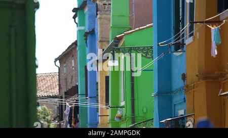 Beautiful colorful houses with clothesline, everyday life in Burano, Venice Stock Photo