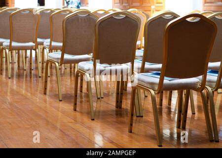 Rows of empty chairs in a conference centre or auditorium. Stock Photo