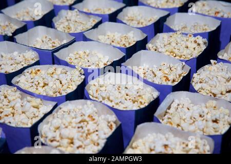 Close-up shot of bags of freshly made, delicious cinema popcorn. Stock Photo