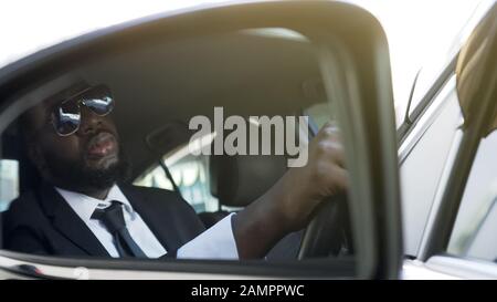 Business driver sitting in auto, wasting time in traffic jam, stressful life Stock Photo