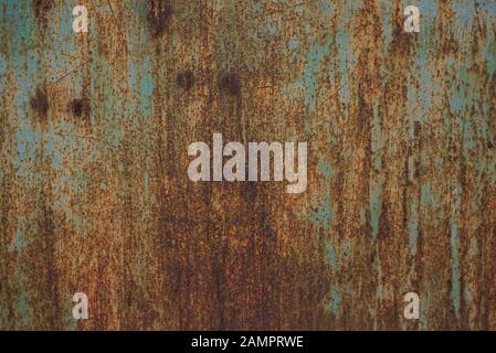 Grungy brushed yellow metal brass plate with screws rusty old metal texture. Blank for background, free space for advertising. Rust on a metal fence. Stock Photo