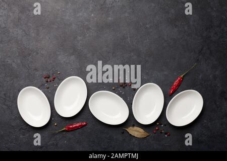 Set of empty sauce bowls and spices on dark stone table. Top view with copy space. Flat lay Stock Photo