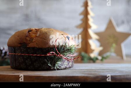Concept of italian food.Traditional Italian Christmas Panettone cake with dried fruits on wooden table. Christmas decorations. Stock Photo