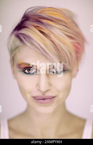 Beautiful blonde hair woman posing in studio. Close up portrait of young attractive model.Smiling lady with stylish short hair Stock Photo