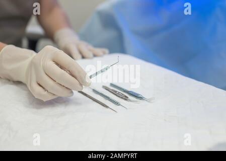 Close-up of an ophthalmologist doctor holding instruments for microscopic eye surgery in his hand over a sterile table The latest treatments for eye d Stock Photo