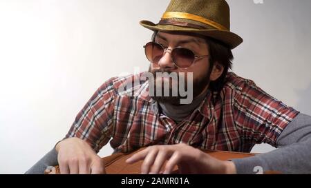 Unhappy young man holding suitcase, upset because of canceled tourist trip Stock Photo