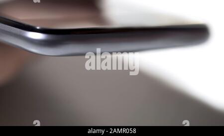 Extreme closeup of smartphone surface, habitual technologies in everyday life Stock Photo