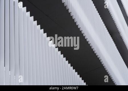 Abstract pattern of metal slats forming privacy railings on modern apartment block walkways. Stock Photo