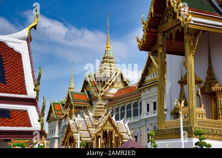 Characteristics of traditional Thai architecture created by artists who transform imagination to reality. Detailed, golden steeply-sloping tile roofs, Stock Photo