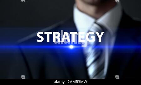 Strategy, businessman standing in front of screen, company business plan concept Stock Photo