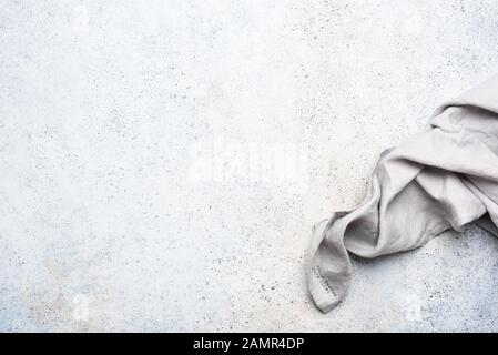 Grey linen kitchen napkin on concrete background. Folded tablecloth. Design background Stock Photo