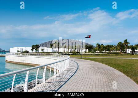 Abu Dhabi, United Arab Emirates - December 20, 2019: Louvre museum in Abu Dhabi exterior and entrance with characteristic architecture on a sunny day Stock Photo