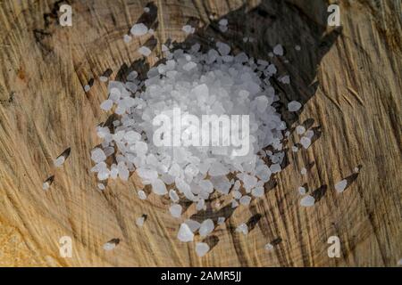 Kitchen salt grain ingredient on wood table, nacl, sodium chloride, food concept Stock Photo