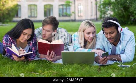 Multiracial students preparing for lessons, talking with each other, education Stock Photo