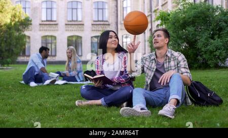 Captain of basketball team flirting with beautiful biracial student relationship Stock Photo