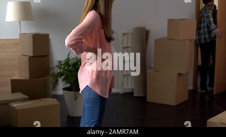 Pregnant wife kicking husband out of house, breakup, problems in family life Stock Photo